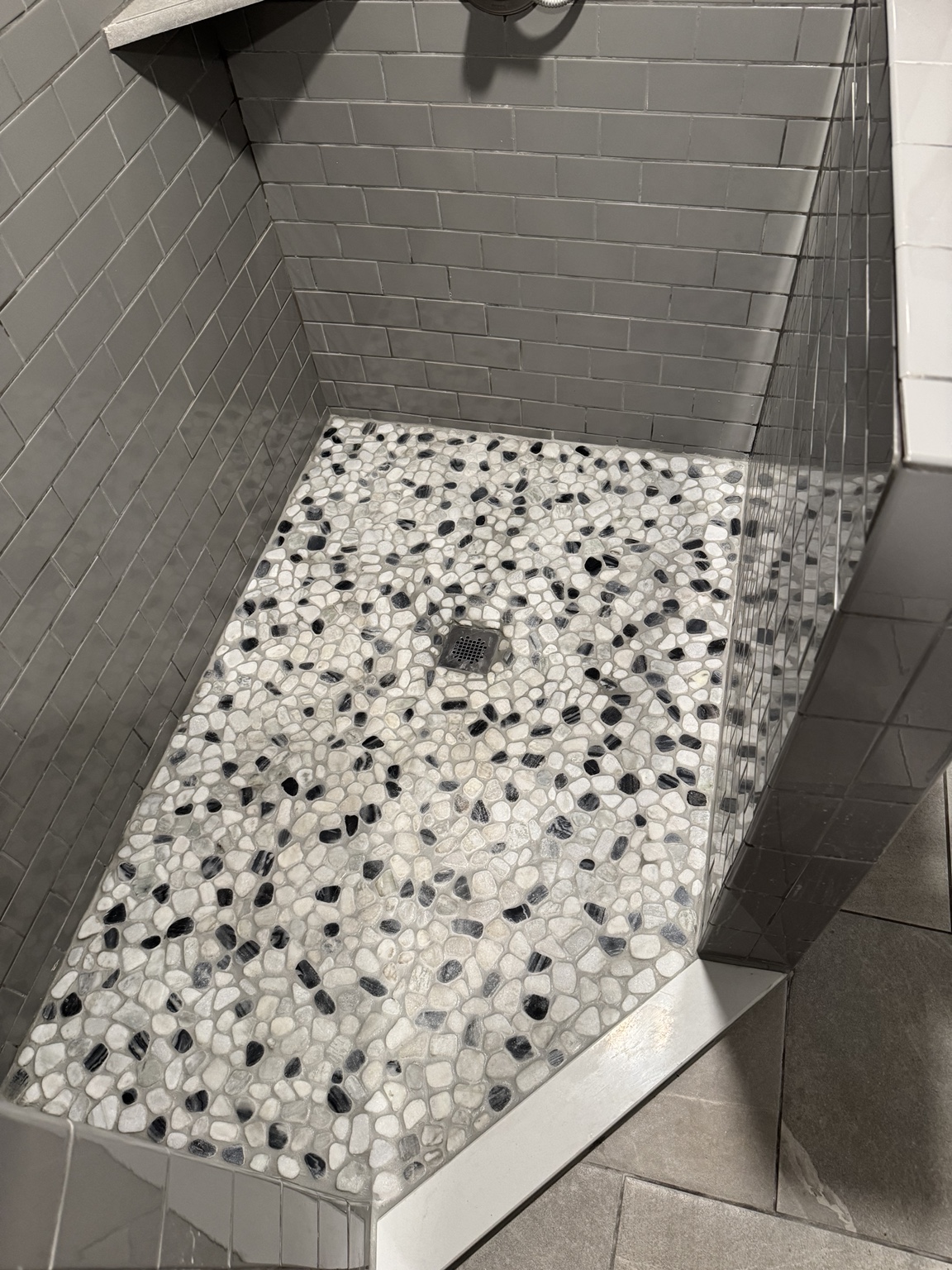 Custom pebble tile shower floor and centered drain